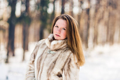 Portrait of woman standing in snow