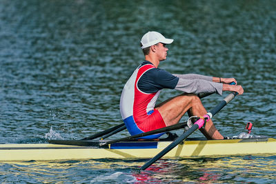 Side view of athlete rowing on sea