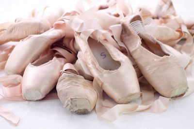 Close-up of damaged ballet shoes on table