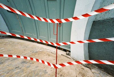 High angle view of metallic fence on footpath