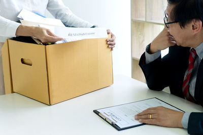 Midsection of man working on table