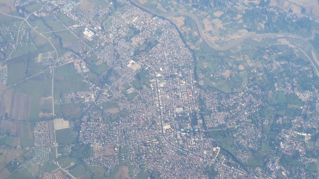 HIGH ANGLE VIEW OF ILLUMINATED CITY BUILDINGS