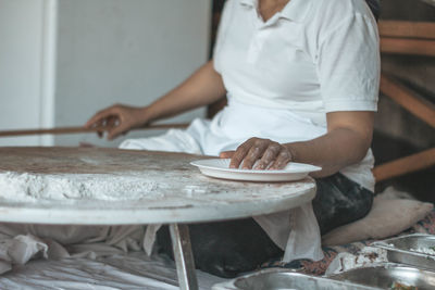 Midsection of man preparing food