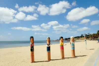 People on beach against sky