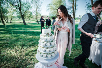 Couple cutting cake during wedding ceremony