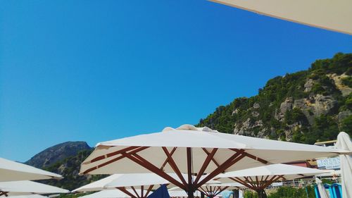 Scenic view of mountains against clear blue sky