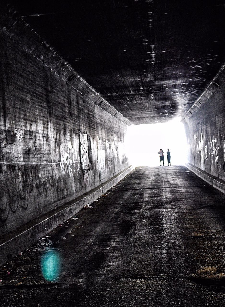 the way forward, walking, tunnel, silhouette, full length, men, lifestyles, diminishing perspective, indoors, leisure activity, vanishing point, rear view, architecture, unrecognizable person, built structure, person, light at the end of the tunnel