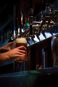 Low angle view of man pouring beer