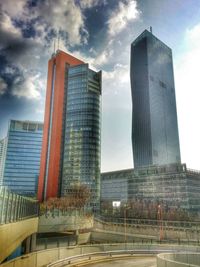 Low angle view of modern building against cloudy sky