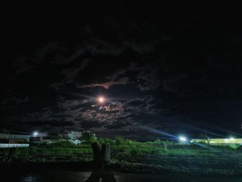 Illuminated lights against sky at night