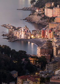 High angle view of townscape by sea against sky