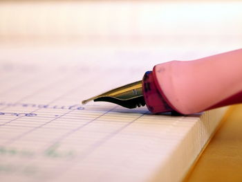 Close-up of fountain pen on book at table