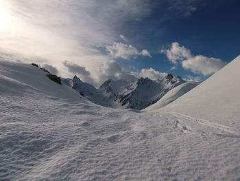 Scenic view of snow covered mountains against sky