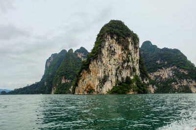 Scenic view of rock formation in sea against sky