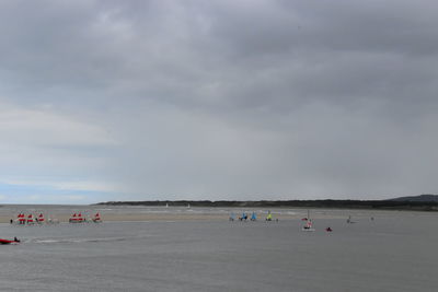 People on beach against sky