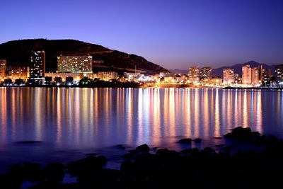 Illuminated city at waterfront