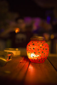 Close-up of illuminated lantern on table in restaurant