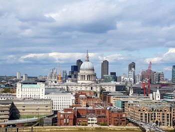 Cityscape against cloudy sky