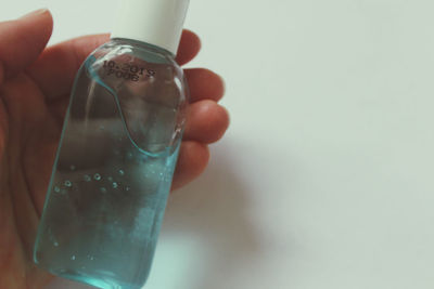 Close-up of hand holding glass bottle