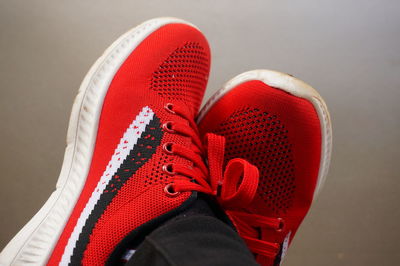 Low section of person wearing red shoes