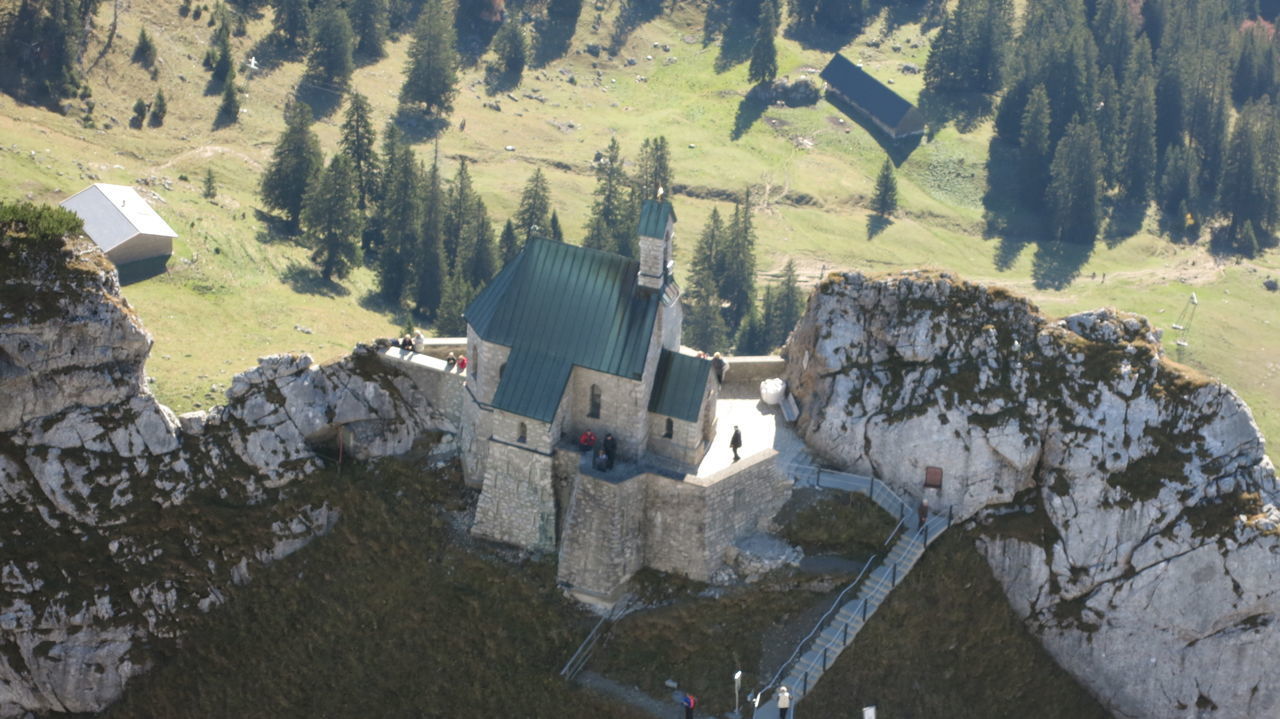 HIGH ANGLE VIEW OF BUILDINGS AND ROCKS AGAINST SKY