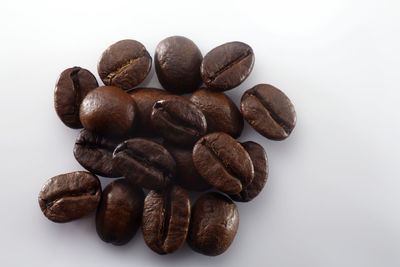 Close-up of coffee beans against white background