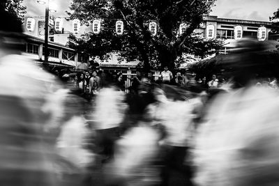 Blurred motion of wet walking on road in city