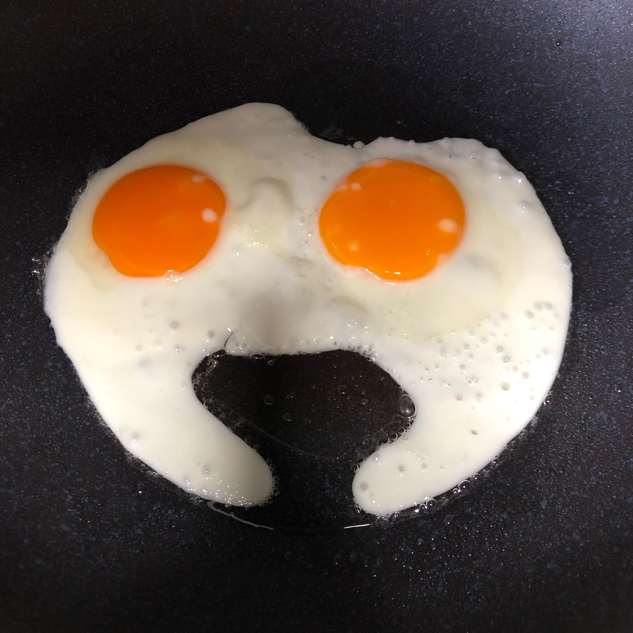 Egg Fried Egg Egg Yolk Fried Food Food And Drink Breakfast Sunny Side Up Frying Pan Indoors  Healthy Eating No People Wellbeing Freshness Close-up Meal Pan Black Anthropomorphic Anthropomorphic Face