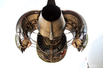 Low angle view of aircraft engine against sky