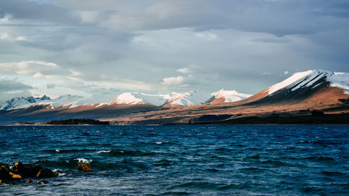 Scenic view of mountains against cloudy sky