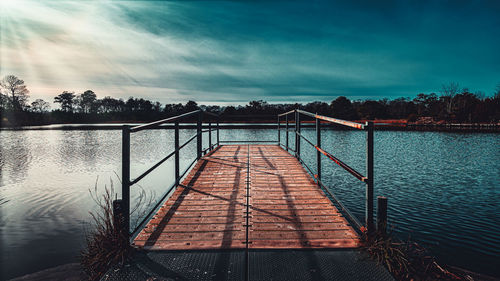 Pier over lake against sky