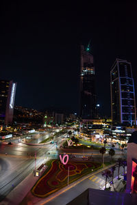 High angle view of illuminated street and buildings at night