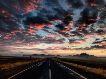 Road against dramatic sky during sunset