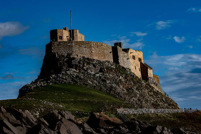 Low angle view of linisfarne castle