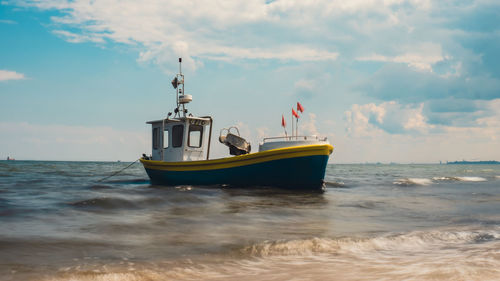 Boat in sea against sky