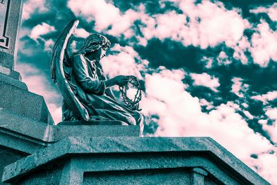 Low angle view of statue against cloudy sky