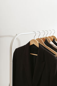 Modern rack with capsule collection in neutral black and beige colours. 
