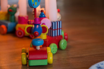 Close-up of toys on hardwood floor at home