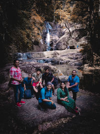 Group of people sitting on rock