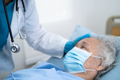 Midsection of doctor examining patient at clinic