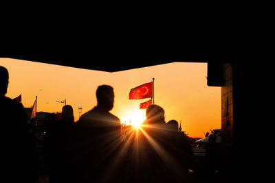 Low angle view of silhouette woman standing against sky during sunset