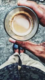 Low section of person holding tea