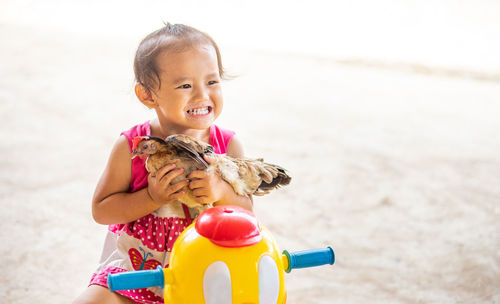 Portrait of cute girl with toy on beach