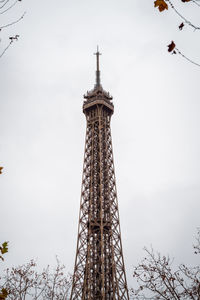 The eiffel tower in paris framed by autumn branches - france