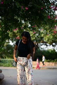 Woman standing against trees