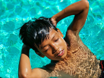 Portrait of happy boy swimming in pool