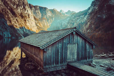 Built structure on rocks against mountain range