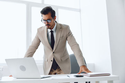 Businesswoman using laptop at office