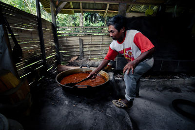 Man preparing food while standing on land