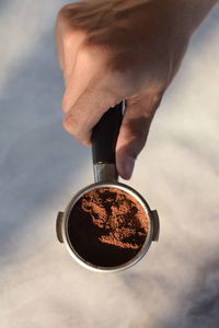 Cropped hand of person holding coffee cup